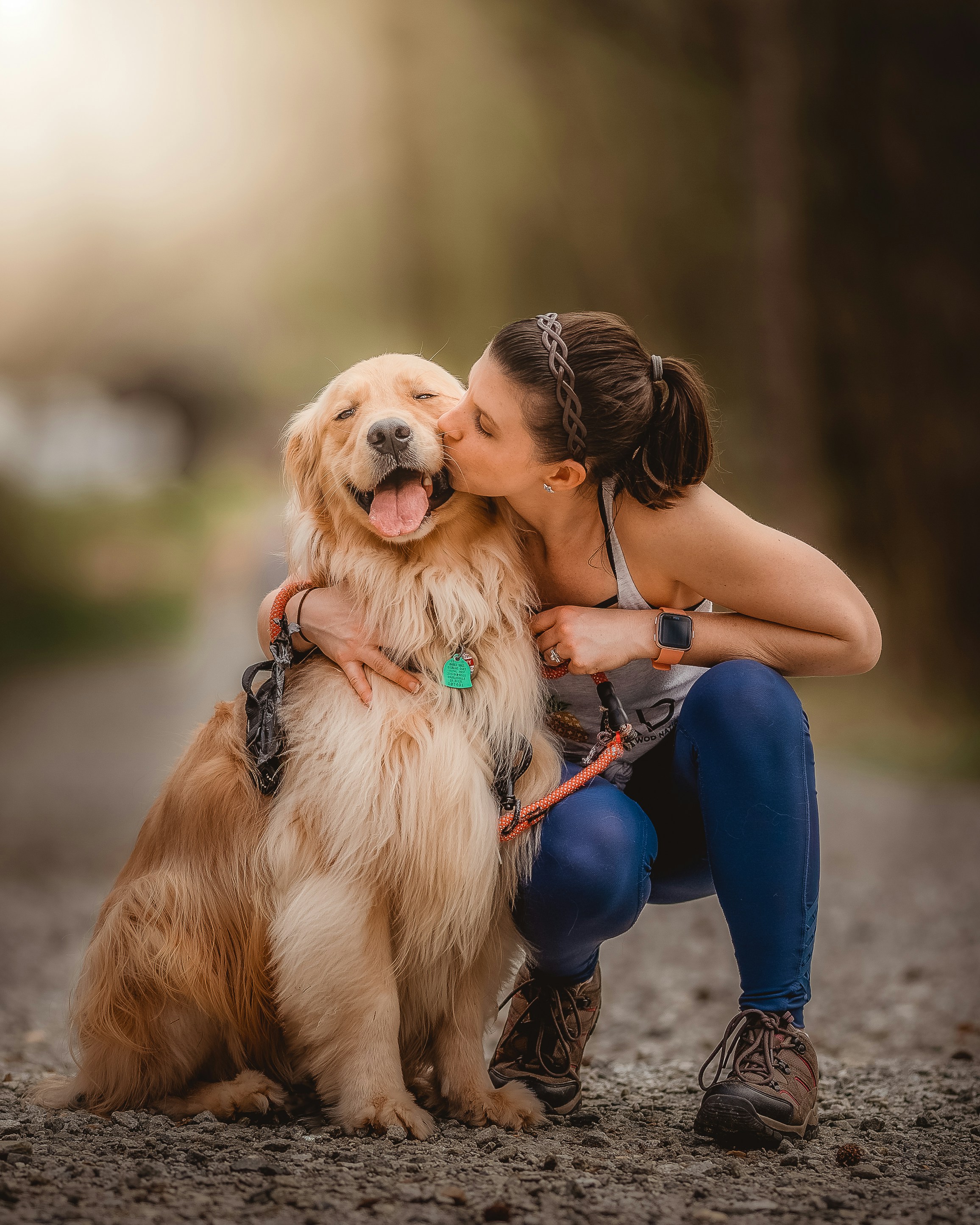 Golden retriever and walker on a trail